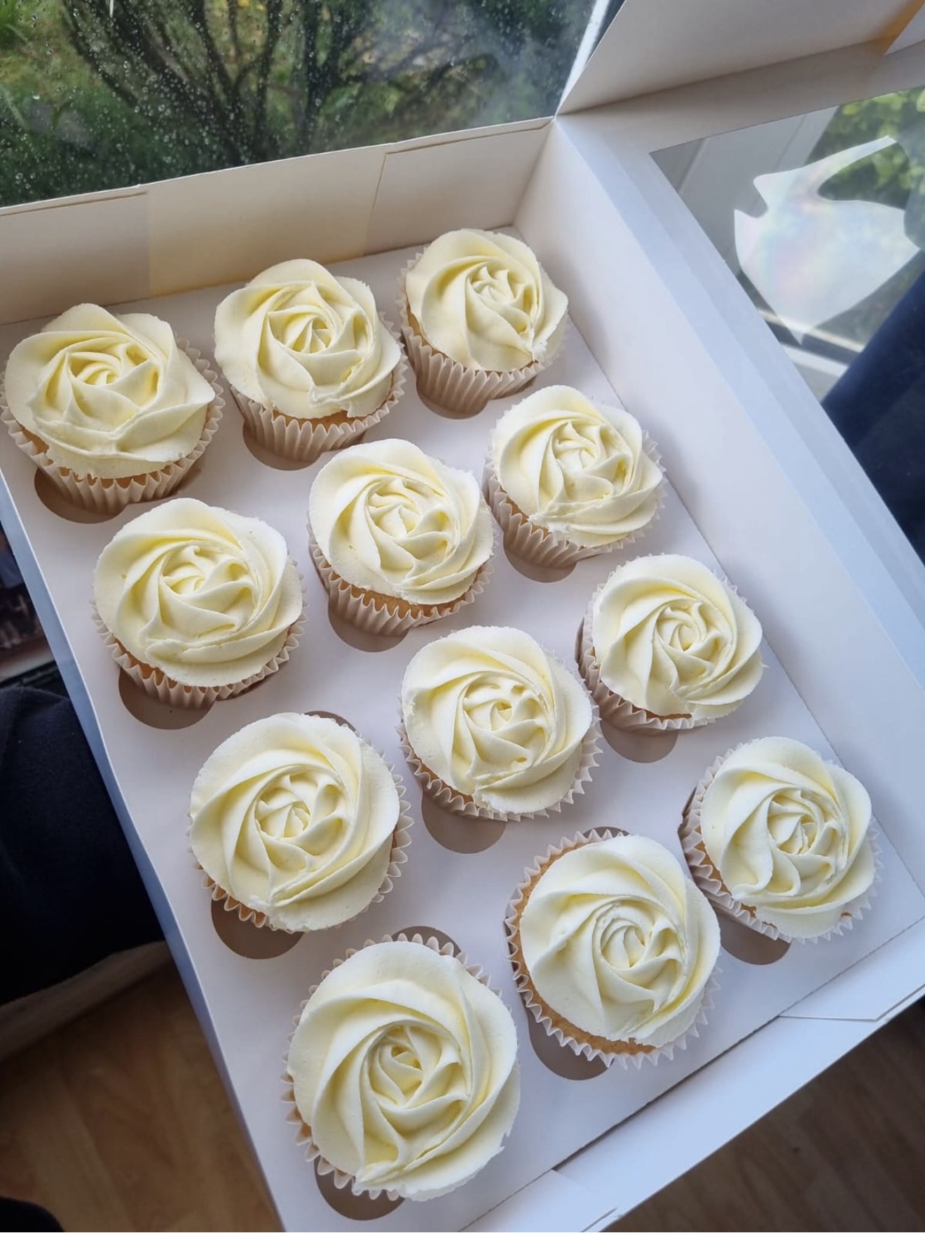 Vanilla cupcakes with white rose piping